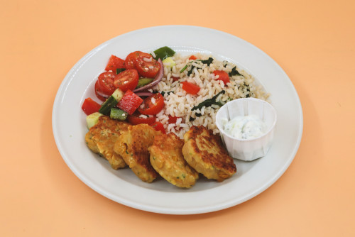  Falafel (chickpea patty) served with brown rice, vegetables, and a side of tangy tzatziki yogurt sauce. 