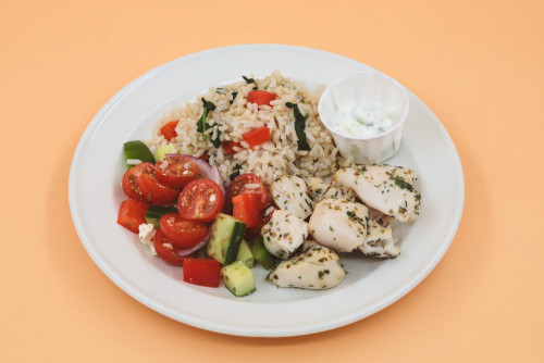  Marinated chicken served with brown rice, vegetables, and  tzatziki yogurt sauce. 